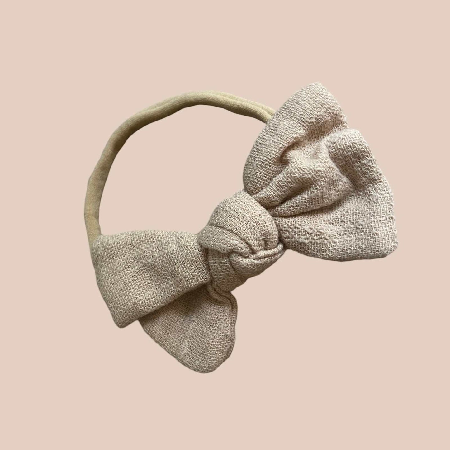 Petite baby bow in sand. Neutral small baby bow headband. Newborn baby bows