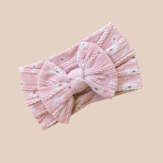 Pink Daisy cable knit baby bow headband. Newborn baby bows