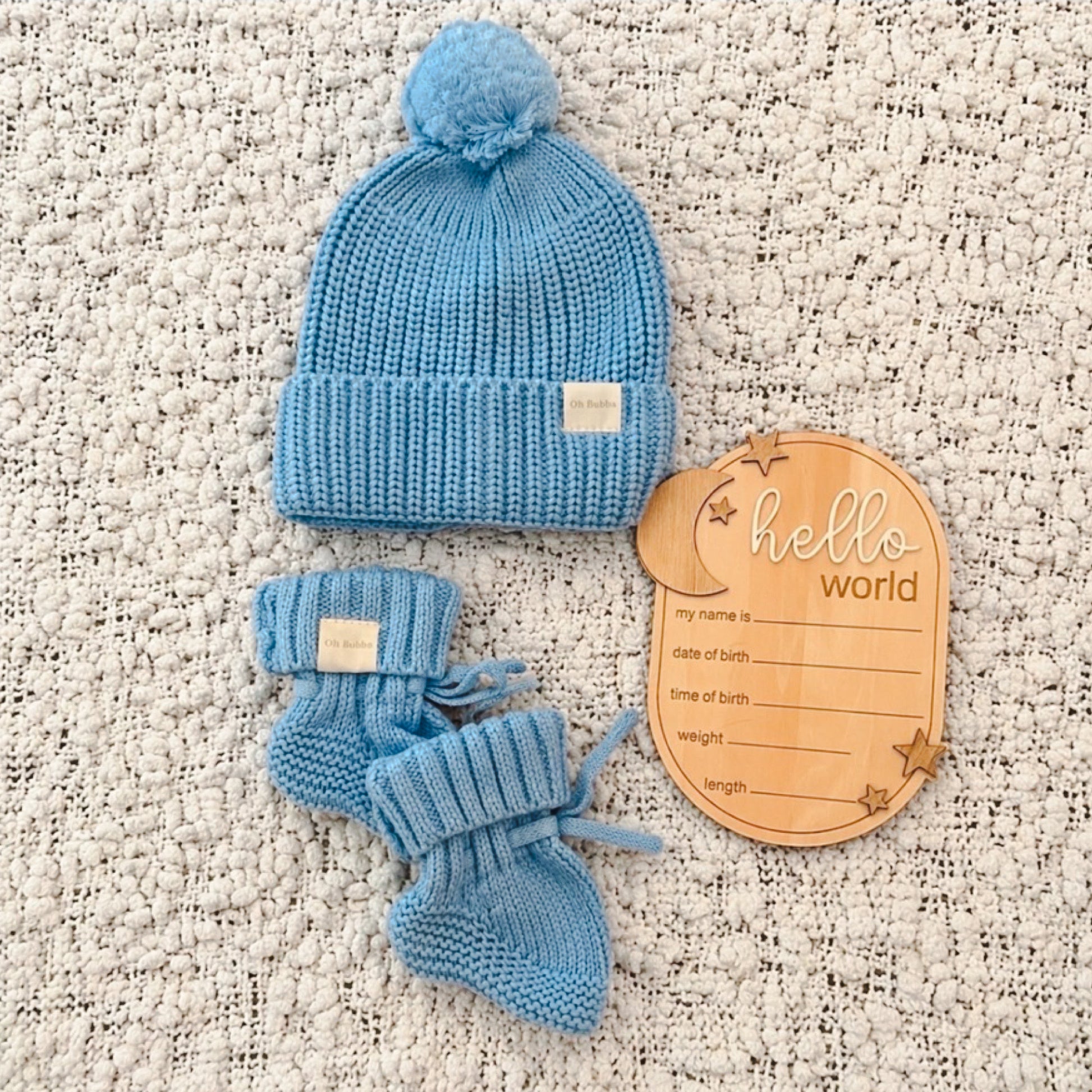 Blue Knit newborn beanie and booties. Hello World announcement disc