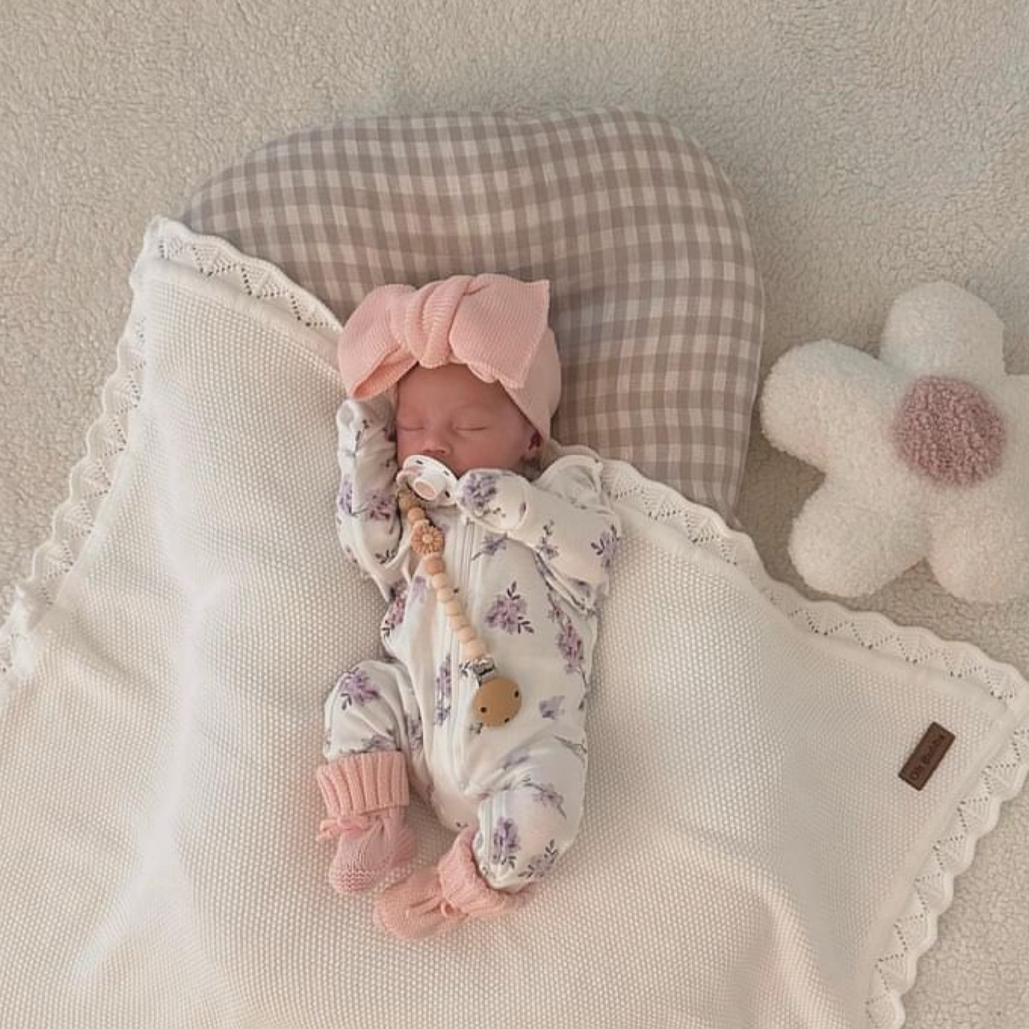 White knit baby blanket and pink knit booties and headband 