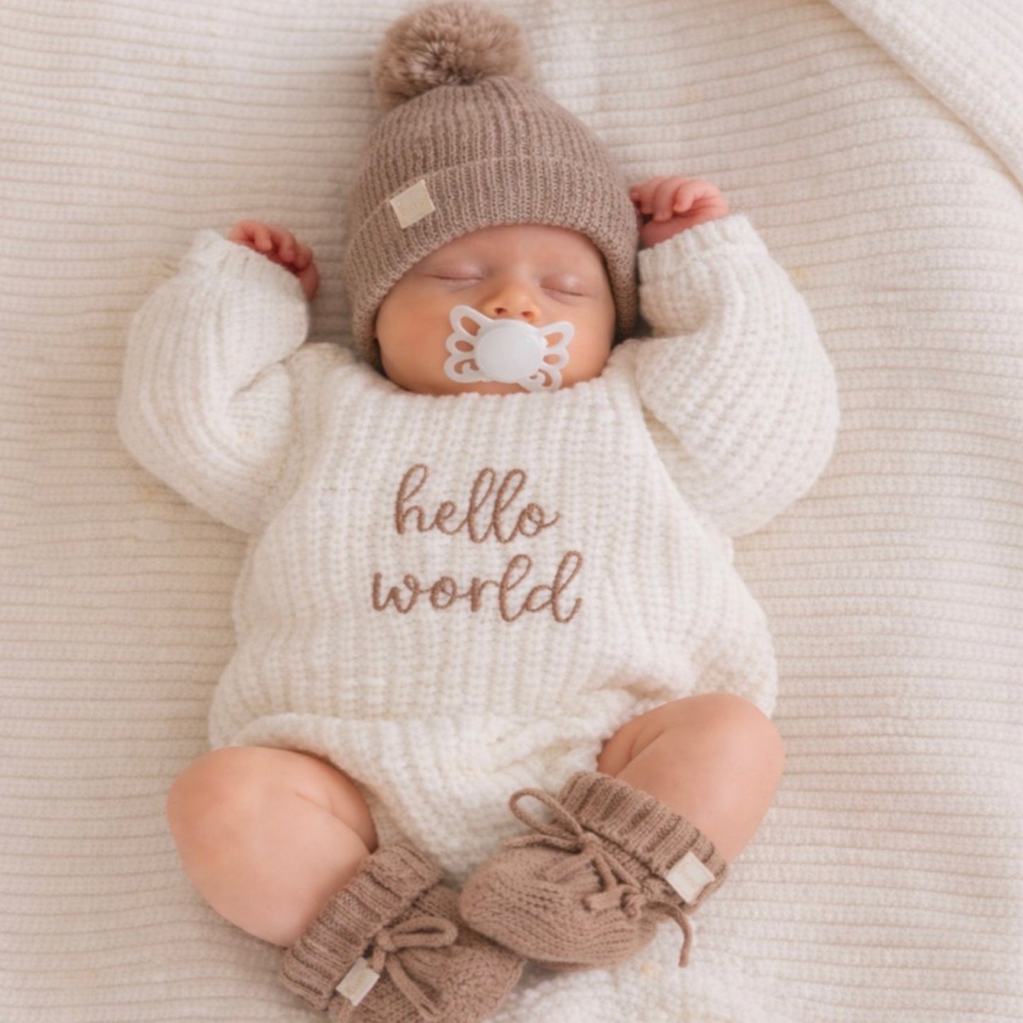 Chocolate brown knit beanie and booties. Hello world knit romper 