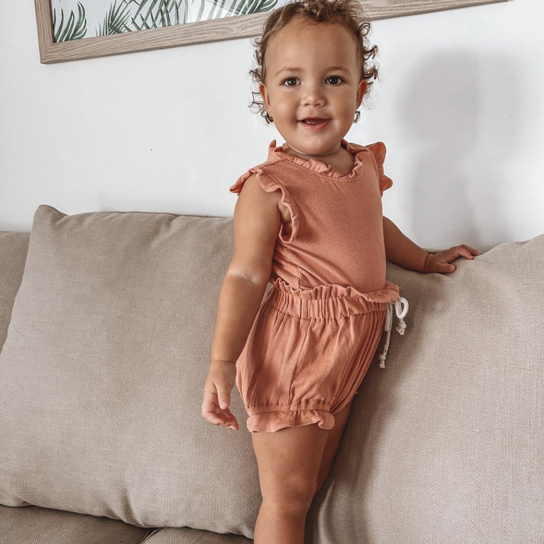 Frill Baby Romper Front Image. Baby girl clothing